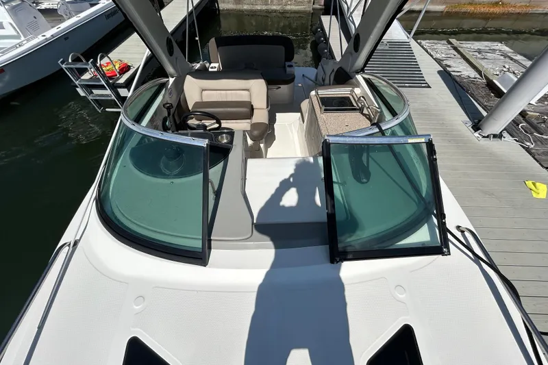 Slide: The Image of Interior view of 2014 Sea Ray Sundancer 260 with seating and wooden table. - 27
