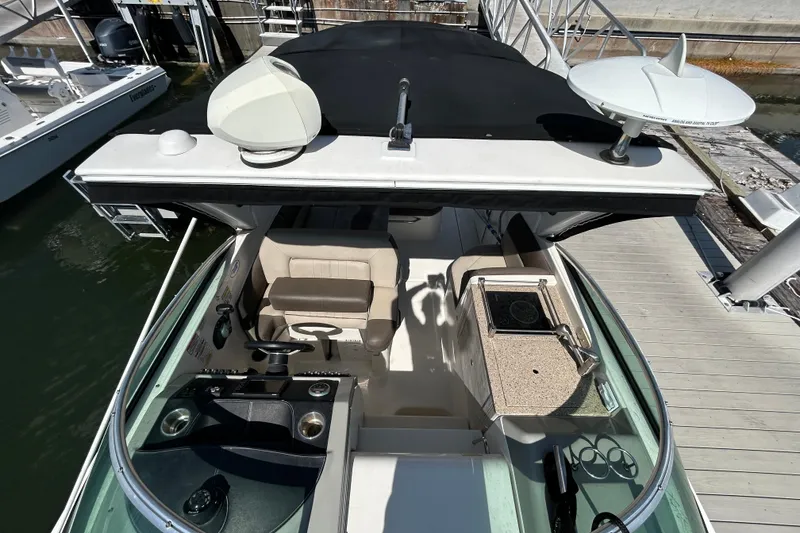 Slide: The Image of 2014 Sea Ray Sundancer 260 cockpit with steering wheel and dashboard controls. - 29