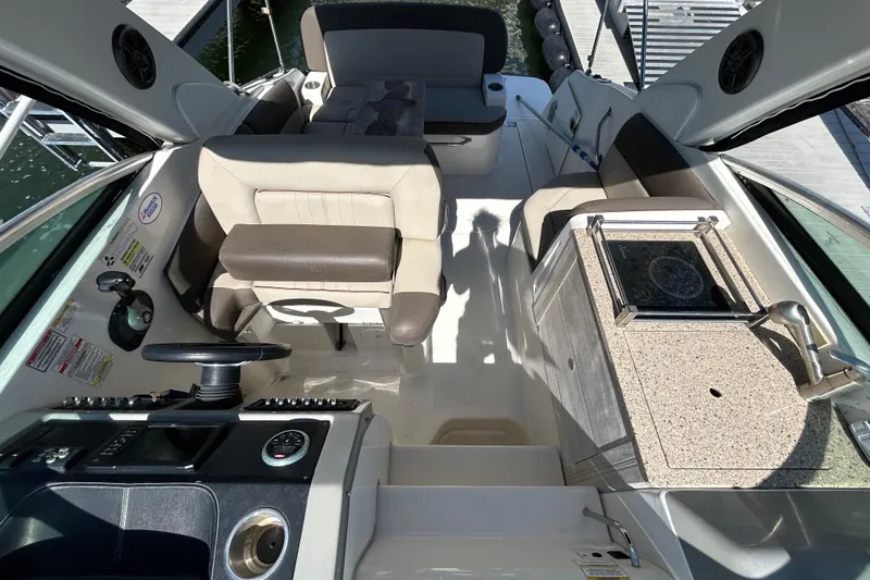Slide: The Image of Cockpit of 2014 Sea Ray Sundancer 260 boat with steering wheel and control panel. - 31