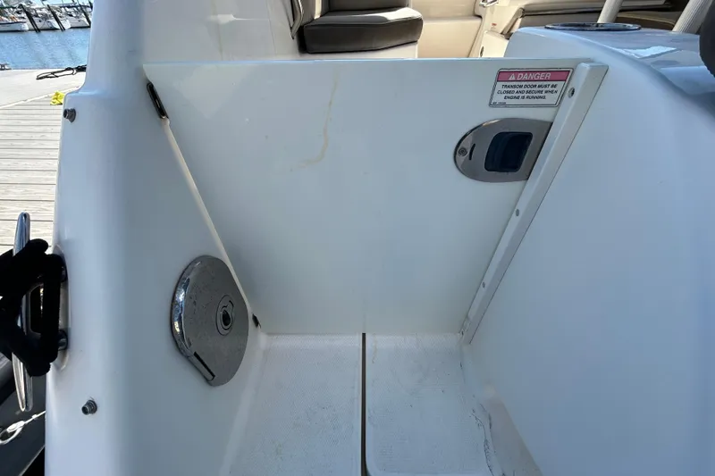 Slide: The Image of Interior view of a 2014 Sea Ray Sundancer 260 boat, showing deck and controls. - 41
