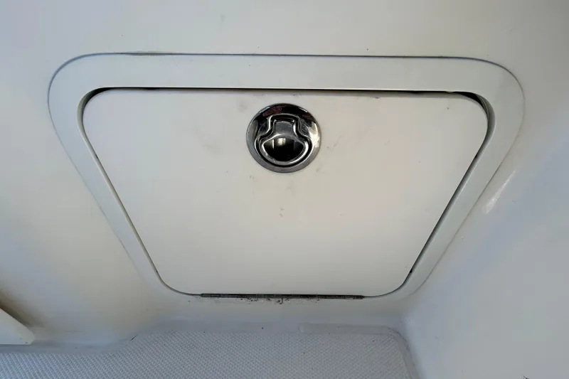 Slide: The Image of 2014 Sea Ray Sundancer 260 cockpit with helm, seating, and kitchenette area. - 42