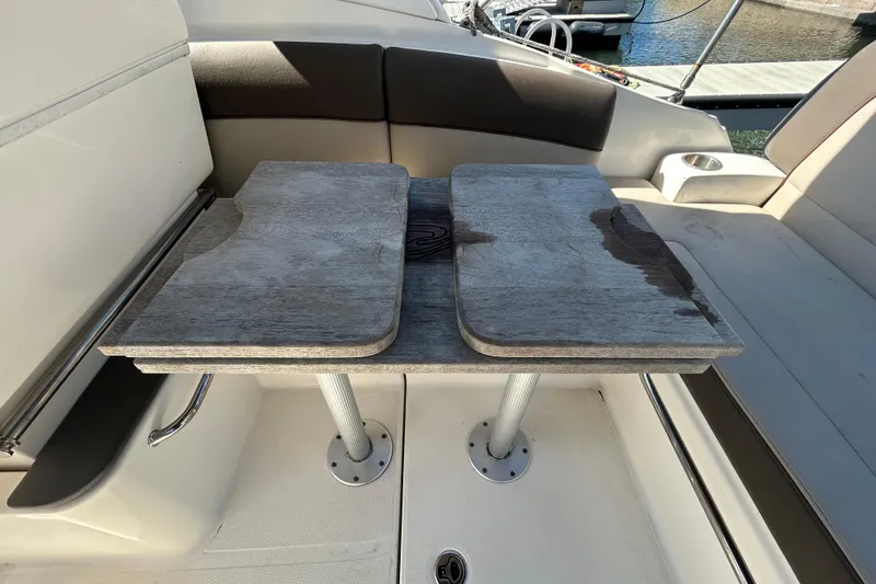 Slide: The Image of Control panel of a 2014 Sea Ray Sundancer 260 boat, featuring electrical switches and gauges. - 53