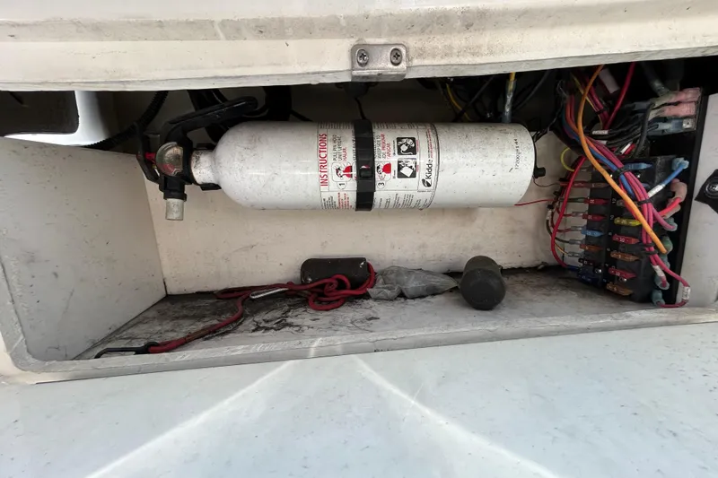 Slide: The Image of 2014 Sea Ray Sundancer 260 cabin storage with life jackets and wooden interior. - 64