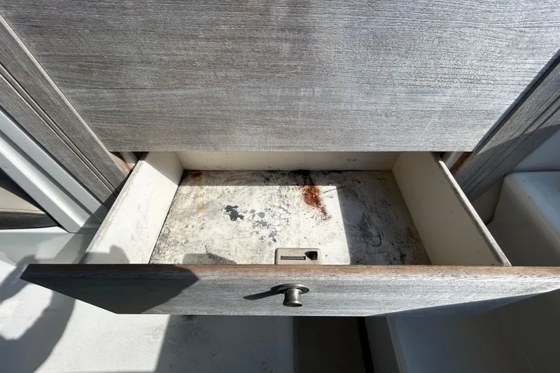 Slide: The Image of 2014 Sea Ray Sundancer 260 cabin interior with sink and storage shelves. - 68