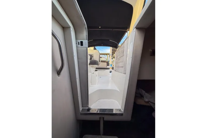 Slide: The Image of 2014 Sea Ray Sundancer 260 interior view with seating and canopy. - 7