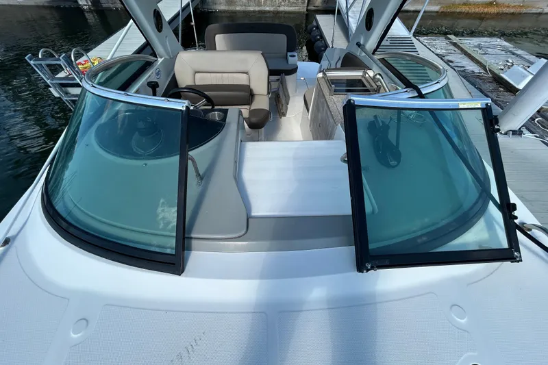 Slide: The Image of Interior of 2014 Sea Ray Sundancer 260 boat with cushioned seating and sunlight streaming in. - 73