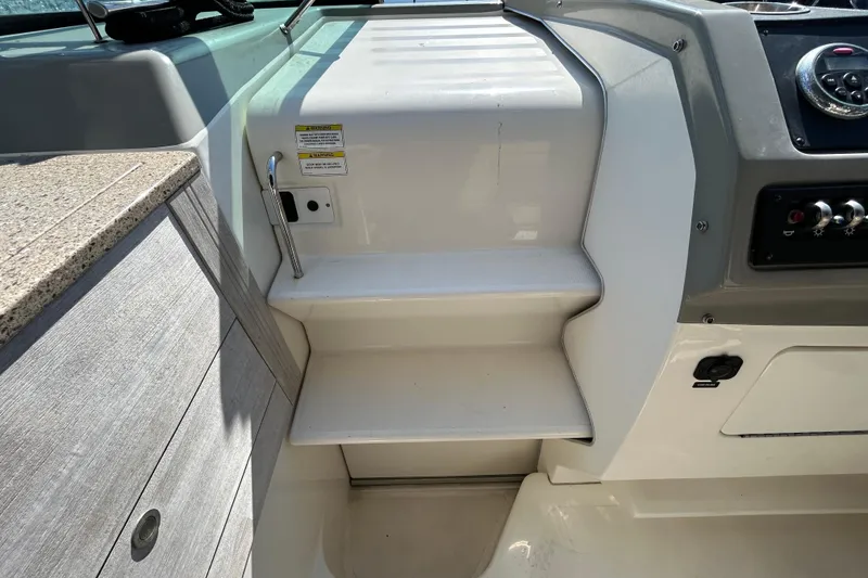 Slide: The Image of 2014 Sea Ray Sundancer 260 boat interior with sunset view, featuring seating and table. - 75