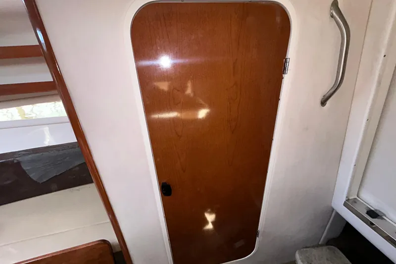 Slide: The Image of Interior of 2014 Sea Ray Sundancer 260 with wooden table and cushioned seating. - 79