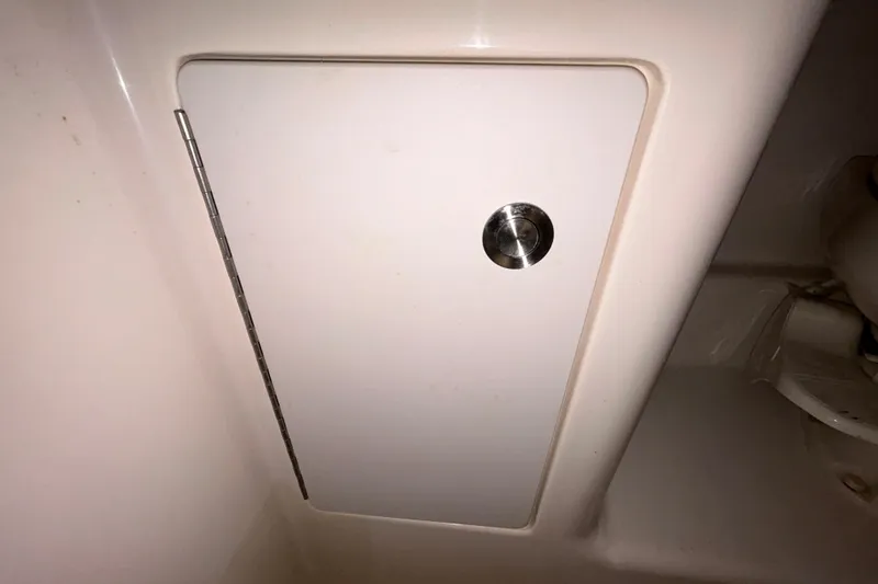 Slide: The Image of 2014 Sea Ray Sundancer 260 boat seat with logo, parked near a road. - 82