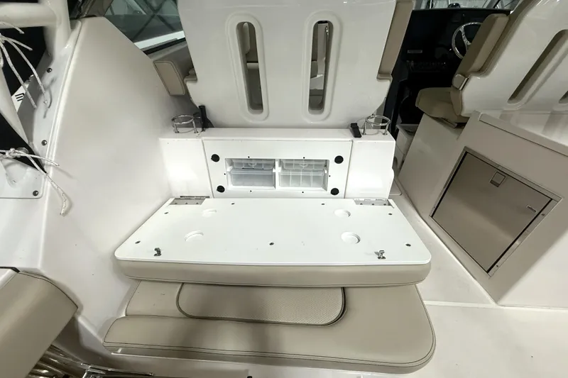 Slide: The Image of 2018 Pursuit DC 325 Dual Console interior with seating and storage compartments. - 20