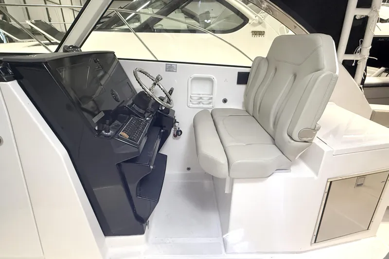 Slide: The Image of 2018 Pursuit DC 325 Dual Console helm with steering wheel and comfortable seating. - 22