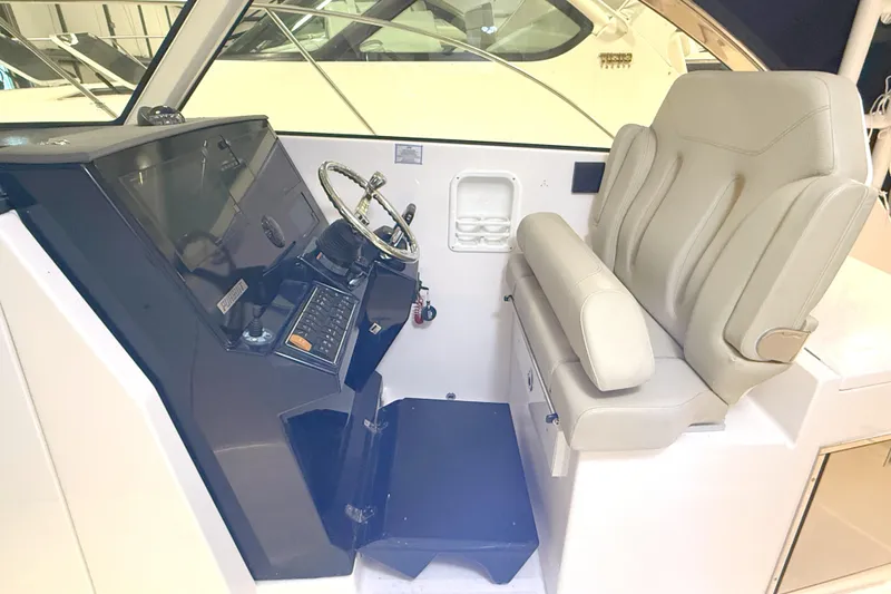 Slide: The Image of 2018 Pursuit DC 325 Dual Console helm with steering wheel and comfortable seating. - 23