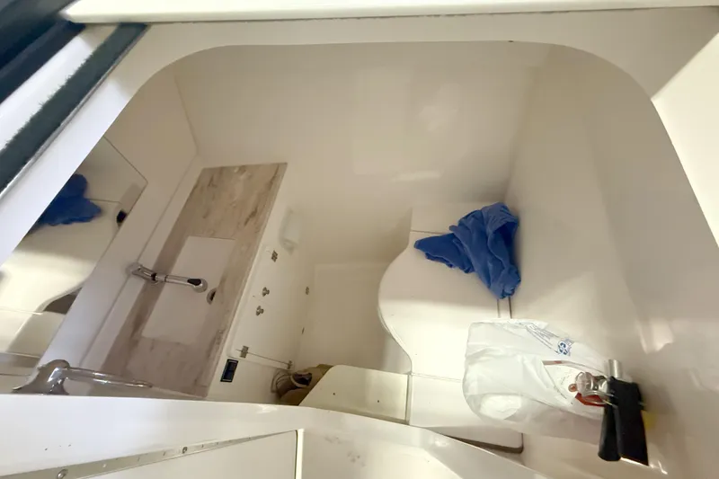 Slide: The Image of 2018 Pursuit DC 325 Dual Console boat interior with sink and storage area. - 27