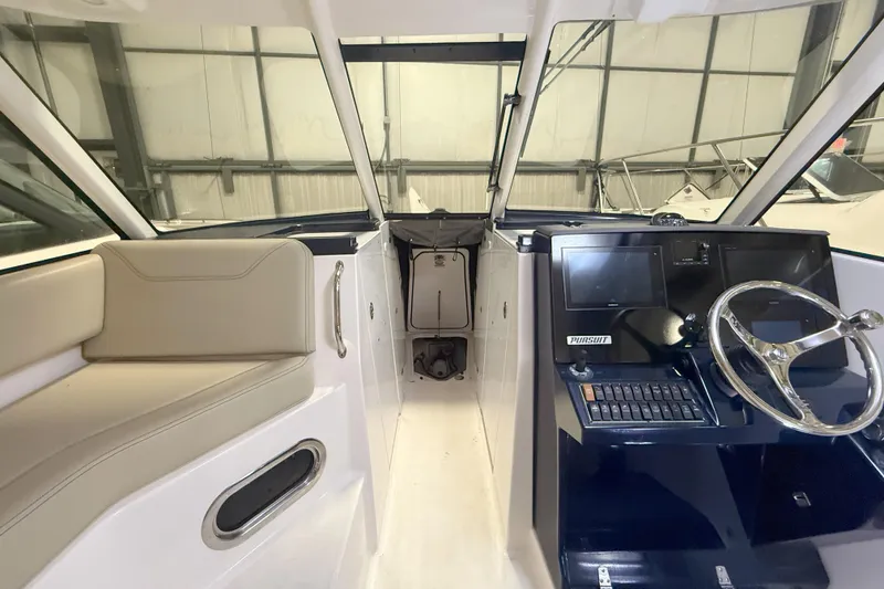 Slide: The Image of 2018 Pursuit DC 325 Dual Console boat interior with steering wheel and seating. - 28