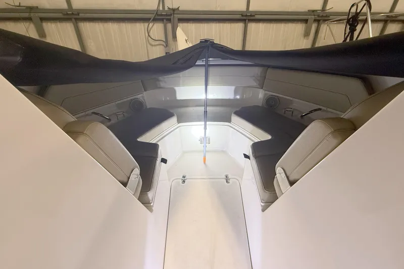 Slide: The Image of 2018 Pursuit DC 325 Dual Console interior with seating and storage in a covered area. - 29