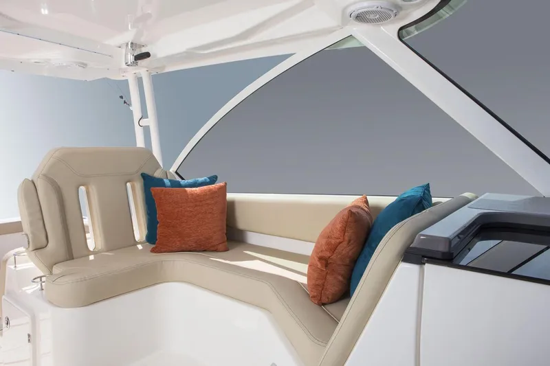Slide: The Image of Manufacturer Provided Image: 2018 Pursuit DC 325 Dual Console boat interior with beige seating and colorful cushions. - 4