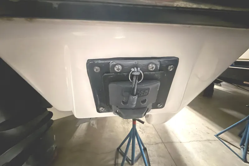 Slide: The Image of 2018 Pursuit DC 325 Dual Console boat detail on support stands in a garage. - 8