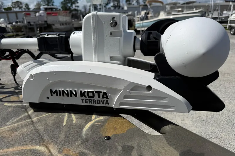 Slide: The Image of Minn Kota Terrova motor on 2022 War Eagle 2170 Blackhawk boat, in a marina setting. - 16