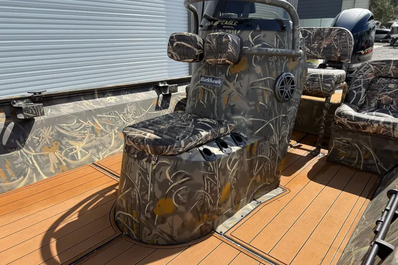 Slide: The Image of 2022 War Eagle 2170 Blackhawk boat interior with camo design and wood-like flooring. - 22