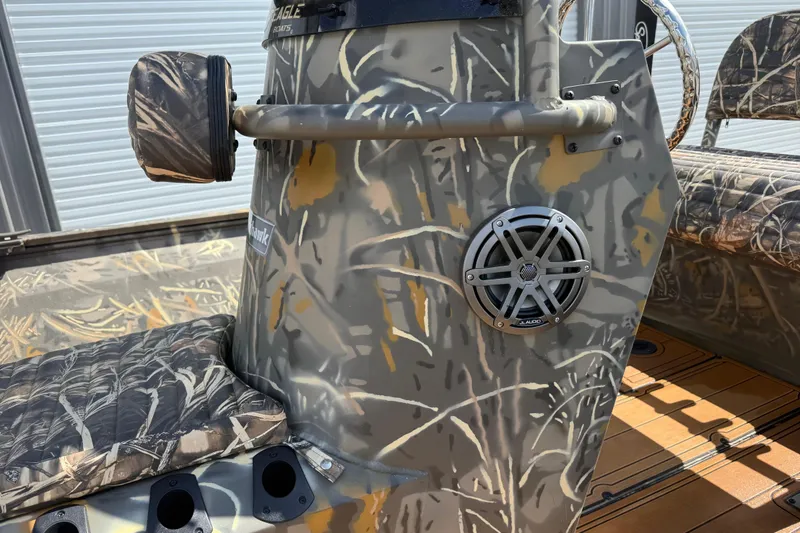 Slide: The Image of 2022 War Eagle 2170 Blackhawk boat with camo design and JL Audio speaker. - 23