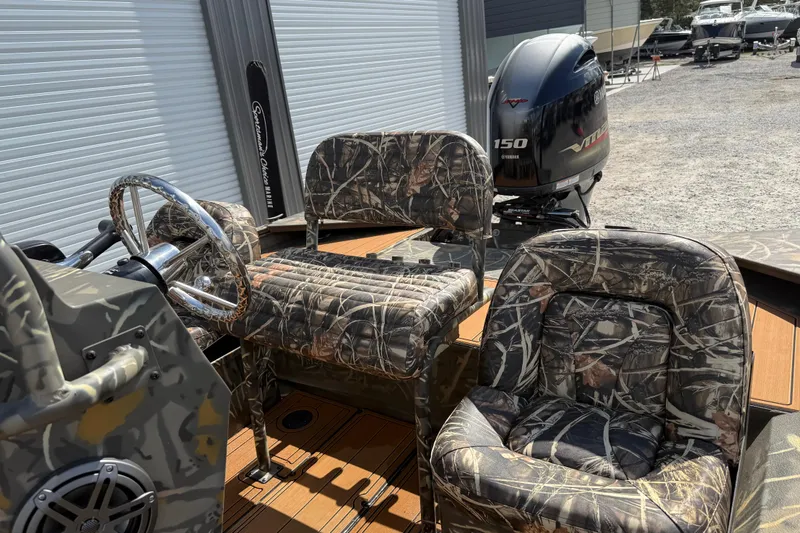 Slide: The Image of 2022 War Eagle 2170 Blackhawk boat with camo seats and Yamaha 150 engine. - 24