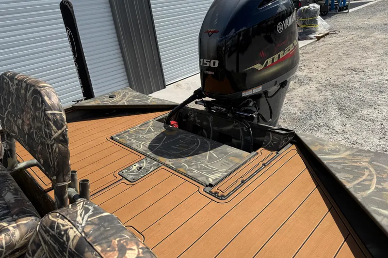 Slide: The Image of 2022 War Eagle 2170 Blackhawk boat with Yamaha VMAX engine, camo seats, and wood-style deck. - 25