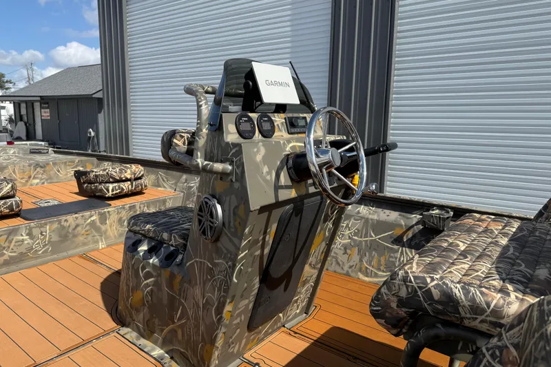 Slide: The Image of 2022 War Eagle 2170 Blackhawk boat with camo design and Garmin navigation system. - 26