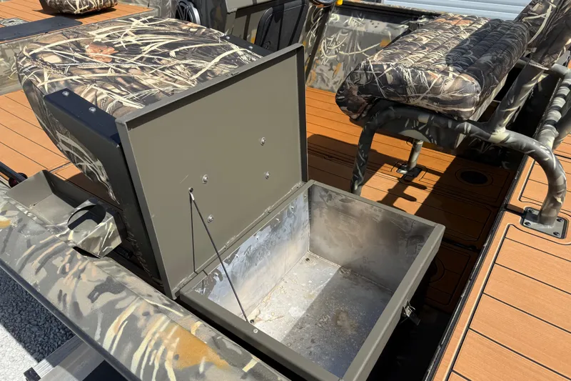 Slide: The Image of 2022 War Eagle 2170 Blackhawk boat interior with camo seats and open storage compartment. - 27