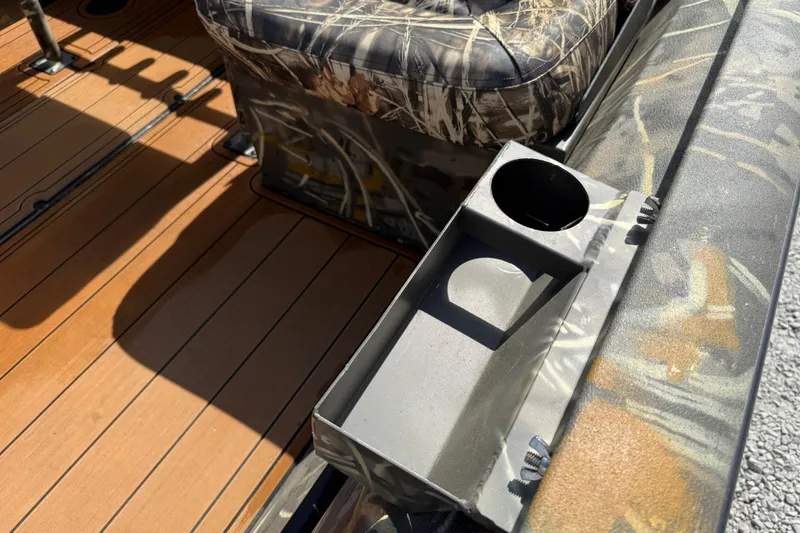 Slide: The Image of 2022 War Eagle 2170 Blackhawk boat interior with camo seat and wooden floor. - 28