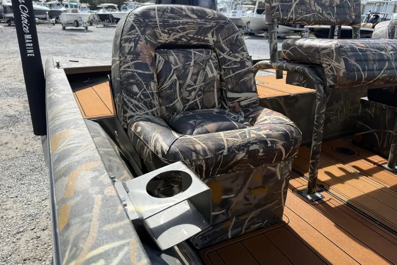 Slide: The Image of Camouflage seating on 2022 War Eagle 2170 Blackhawk boat, featuring cup holder and wood-textured flooring. - 30