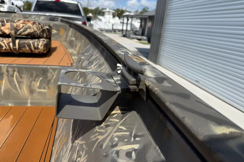 Slide: The Image of 2022 War Eagle 2170 Blackhawk boat with camouflage interior and cup holder detail. - 31