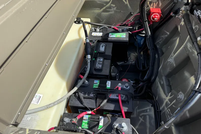 Slide: The Image of Battery compartment of a 2022 War Eagle 2170 Blackhawk boat, showing wiring and connections. - 35