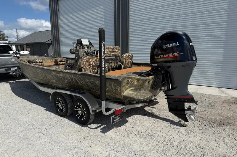Slide: The Image of 2022 War Eagle 2170 Blackhawk boat with Yamaha VMAX engine, parked on gravel. - 4