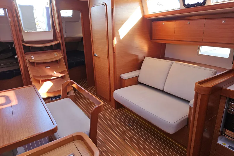 Slide: The Image of Interior of 2018 Dufour 460 Grand Large yacht with wooden finish and cozy seating. - 10