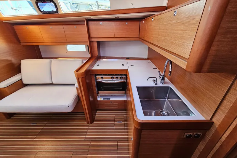 Slide: The Image of Luxurious 2018 Dufour 460 Grand Large yacht interior with modern kitchen and seating area. - 11