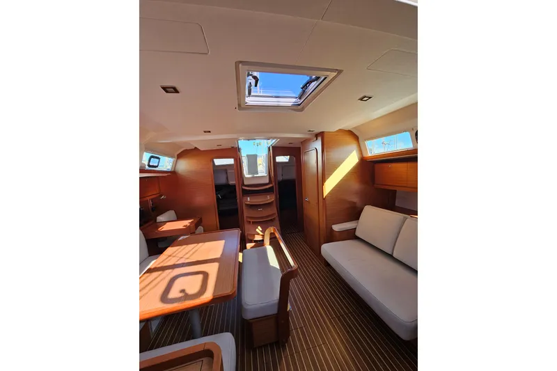 Slide: The Image of Interior of 2018 Dufour 460 Grand Large yacht, featuring elegant wood finishes and modern design. - 12
