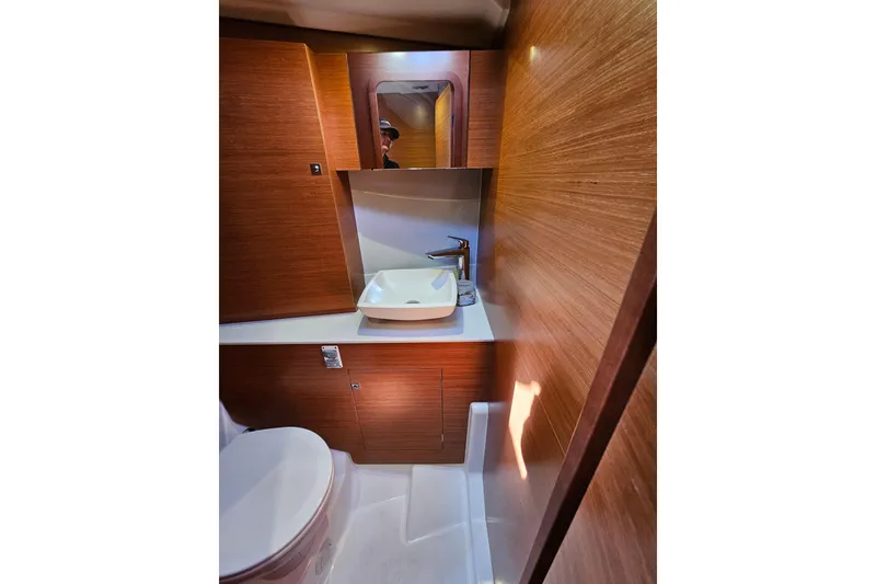 Slide: The Image of Luxurious bathroom in 2018 Dufour 460 Grand Large yacht with modern fixtures and wood paneling. - 15