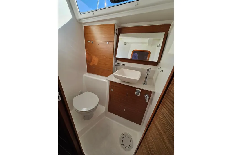 Slide: The Image of 2018 Dufour 460 Grand Large yacht bathroom with modern fixtures and wooden cabinetry. - 20