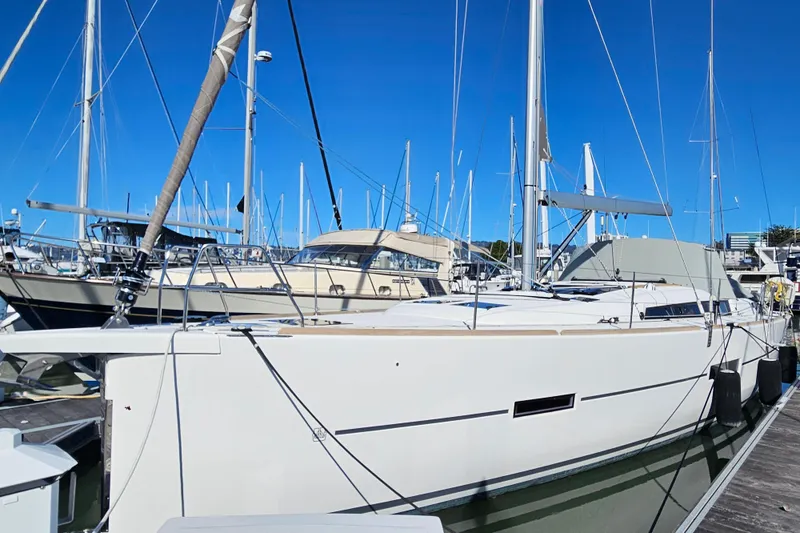 Slide: The Image of 2018 Dufour 460 Grand Large sailboat docked at marina under clear blue sky. - 23