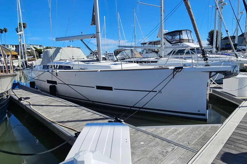 Slide: The Image of 2018 Dufour 460 Grand Large yacht docked at marina under clear blue sky. - 24