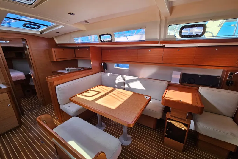Slide: The Image of Interior of 2018 Dufour 460 Grand Large yacht with wooden furnishings and seating area. - 25