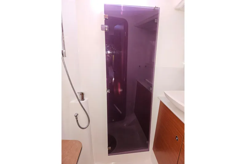 Slide: The Image of 2018 Dufour 460 Grand Large yacht bathroom with purple glass shower door. - 26