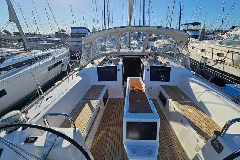 Slide: The Image of 2018 Dufour 460 Grand Large yacht cockpit with wooden seating and navigation equipment. - 3
