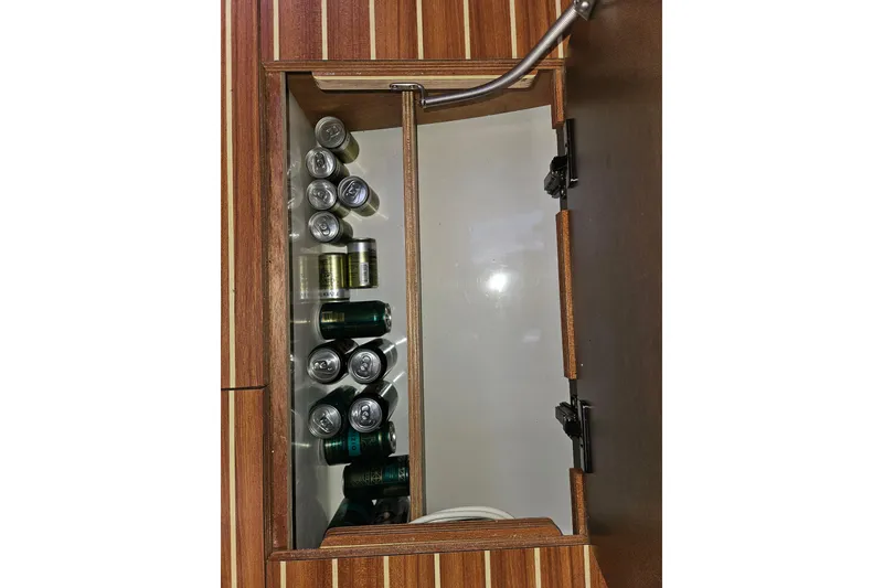 Slide: The Image of Storage compartment with canned beverages on a 2018 Dufour 460 Grand Large yacht. - 33