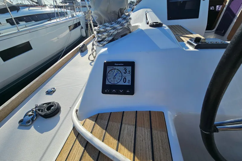 Slide: The Image of 2018 Dufour 460 Grand Large yacht cockpit with navigation display and steering wheel. - 38
