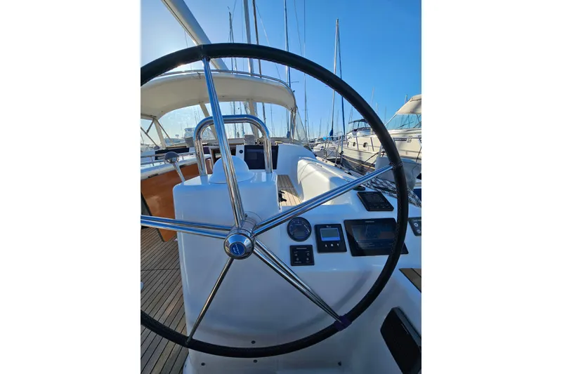 Slide: The Image of 2018 Dufour 460 Grand Large yacht cockpit with steering wheel and navigation instruments. - 4