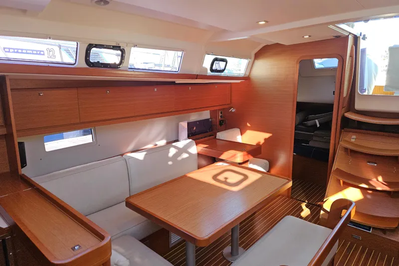 Slide: The Image of Interior of 2018 Dufour 460 Grand Large yacht with wooden furnishings and seating area. - 7