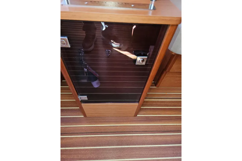 Slide: The Image of Wooden interior of 2018 Dufour 460 Grand Large yacht with glass cabinet door. - 8