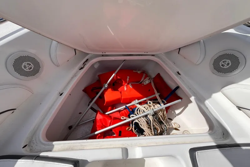 Slide: The Image of Open storage compartment in 2014 Tidewater 196 DC Explorer boat with life jackets and ropes. - 13