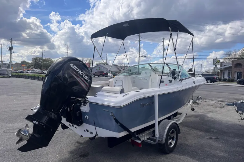 Slide: The Image of 2014 Tidewater 196 DC Explorer boat with Mercury outboard motor, parked on a trailer. - 5